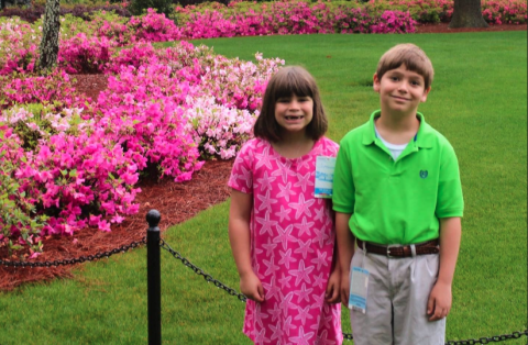 Right before the rains came, Vivian Fargason (left) and her brother Reid pose for a picture in front of the Augusta National clubhouse on April 9, 2019. 