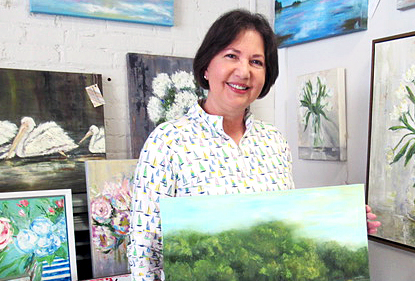 Angie Short posing with her favorite painting from her oeuvre. Photo by Rachel Black.