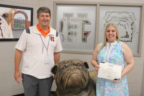 Hart County High School’s athletic director Cory Dickerson (left) presents HCHS girls tennis coach Erin Gaines (right) with the Most Positive Girls Coach Award on May 10.