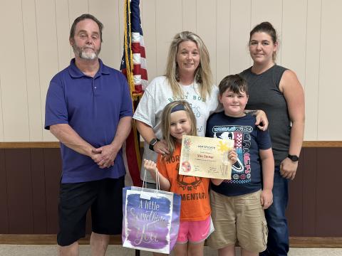 The Bowersville City Council presented the winner of the Georgia Cities Week coloring contest with a certificate and a gift bag at their May 16 meeting. Pictured left to right: Mayor John Smith; council member Alicia Barnett with winner Xavi Farmer and Farmer’s brother, Koda Phillips; and the children’s mother, Cheyenne Phillips. 