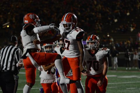 Rising sophomore quarterback Kurston Curry celebrates with teammates after rushing in the endzone for a touchdown against Lumpkin County in the 2023 season, as he will take over under center for the Bulldogs this upcoming season.