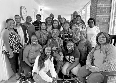 The Senior Center’s longest-attending member, Idell Morrison (center), surrounded by her family and holding the plaque that will hang in the new porch in her honor. 