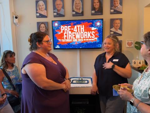 Rachel Black /The Hartwell Sun Hart Chamber of Commerce Executive Director Lindsey Ingle (right) and Assistant Director Amanda Brown speak to community members during the Chamber’s 75 anniversary ceremony June 4.  