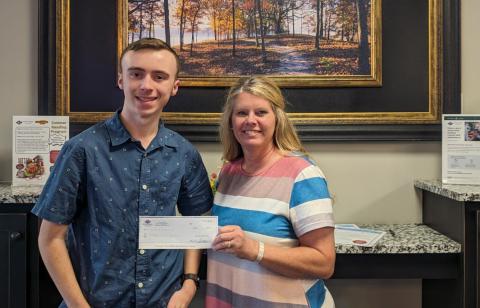 Hart County Senior Sawyer Strickland receives a scholarship check from Kim Little at North Georgia Credit Union 