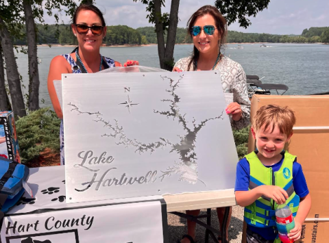 Joanie Haley (left) was declared the winner of the pontoon poker run. She won with a full house, and chose to take the metal map of Lake Hartwell. She posed for the picture with Laura Dickerson and her son Jordan Haley. 