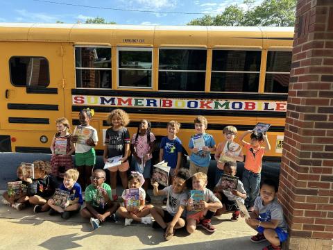 The 2024 summer bookmobile presented by Hart Partners makes a stop at a local elementary school. 