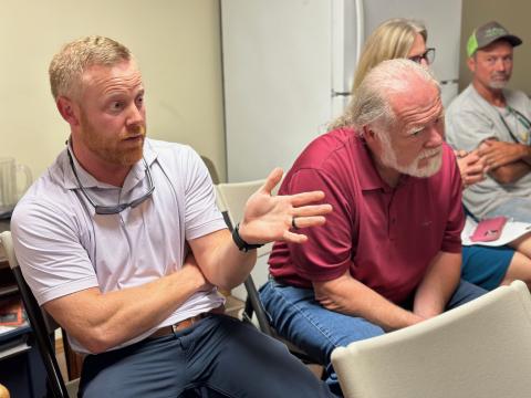 Commissioner Jeff Brown (left) speaks during the Bowersville Town Council meeting as Chairman Marshall Sayer listens in. 