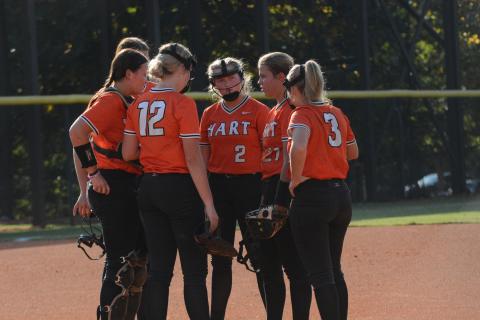 The Lady Dogs meet at the mound during a seven run second inning in the 15-0 run rule against the Lady Wolverines of Prince Avenue Christian on Sept. 24.