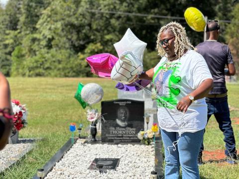 Crystal Thornton (left), the wife of the late Roberius Thornton who was shot and killed in an altercation at a local nightclub two years ago, hosted a balloon release at her husband’s grave site Sept. 2. Thornton is still searching for answers regarding her husband’s death, which remains and unsolved crime. 