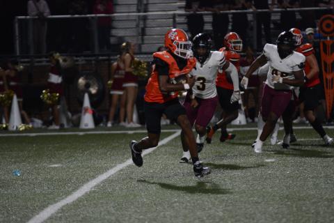 Sophomore quarterback Kurston Curry attempts to evade the pressure from the Lions defense in the 45-0 loss Oct. 4.