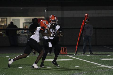Sophomore quarterback Kurston Curry hands the ball off to sophomore running back Faustino Rangel, who scores three rushing touchdowns in the 40-10 win over the Eagles of East Jackson on Oct. 18. Photo by Cheyenne Tolleson/Jackson Harold TODAY