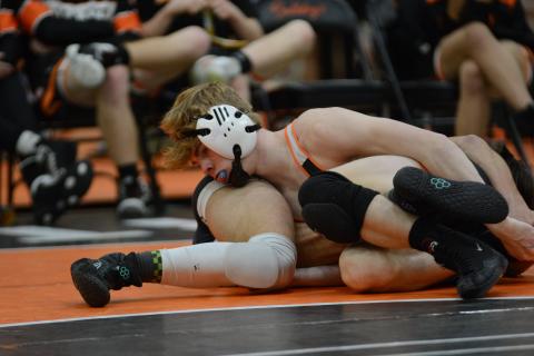 Senior Harrison Krause looks to pin his opponent during a home meet in 2023-2024.