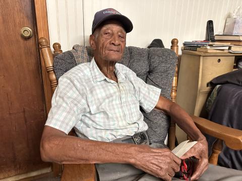 Clifford Jones, a World War II veteran, holding his honorable discharge letter from 1946. 