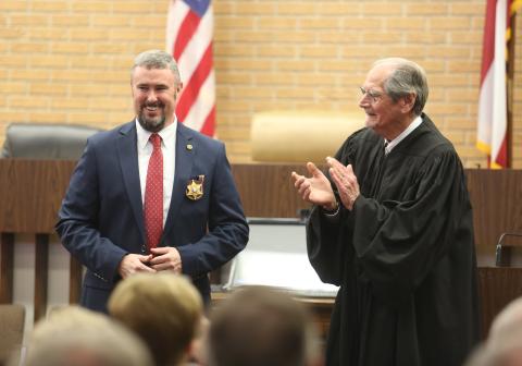 Northern Judicial Circuit Superior Court Judge Chris Phelps (right) claps for Hart County Sheriff Chris Carroll (left) after swearing him into office Dec. 30 inside the Hart County Courthouse. 