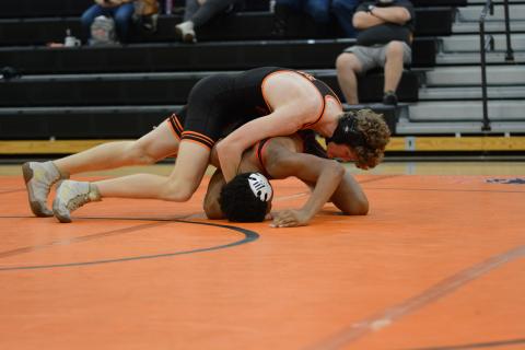 Senior Ethan Stovall pins his opponent to help the Mat Dogs rally back in the 48-34 win over Harlem on Nov. 20.
