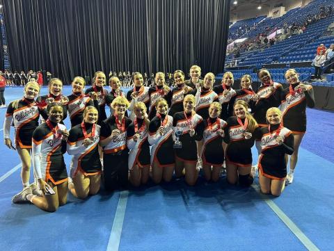 The Hart County High School sideline cheer squad flashes their medals and trophy after claiming state runner-ups at the GHSA gameday competition in Columbus, Ga. on Dec. 4.