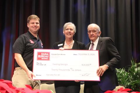2024 Georgia Farm Bureau Young Farmer Committee Chair Cleve Jackson, left, and GFB President Tom McCall, right, present a check for the proceeds of the 2024 Harvest for All campaign to Georgia Food Bank Association Executive Director Danah Craft (center) during the 2024 GFB Annual Convention on Jekyll Island. Photo courtesy of Georgia Farm Bureau.