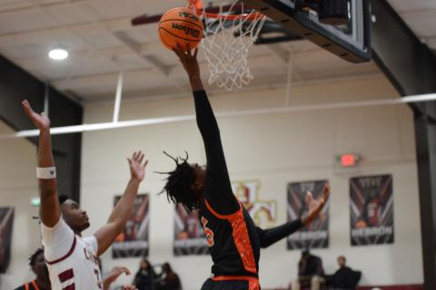 Junior forward Ramarcus Simpson lays it in for the score in the 64-60 loss to Hebron Christian on Jan. 28.