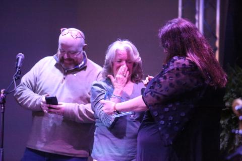Debbie Kulcsar reacts to being named the Community Champion by Hart County Chamber of Commerce Executive Director Amanda Brown as Downtown Development Authority Director Jason Ford smiles in the background during the chamber’s annual awards banquet Feb. 21 at The Station of Hartwell. 
