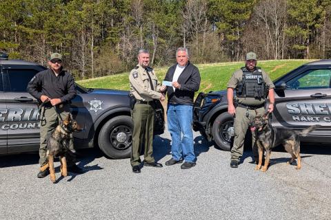 Pictured during a donation to purchase a third drug dog for the Hart County Sheriff’s office are (L-R) Deputy Steve Williams and Jax, Sheriff Chris Carroll, Matt Denton and Deputy Luke Bennett and Zeek.