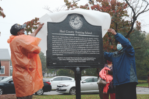 Thomas Morrison, left, and Michael Partlow, right, unveil the new historical marker from the Georgia Historical Society at the former Hart County Training School on Richardson Street on Oct. 10, 2020. Photo by former editor/publisher Michael Hall.