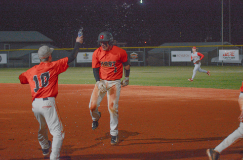 Junior outfielder Boston Graham (right) celebrates with teammates after walking it off against the Red Raiders of Madison County in the 2-1 win on Feb. 24 at Saye Field.  