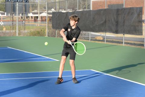 Caleb Carter returns the serve as Carter and Hudson Wise claimed the win at No. 2 doubles to help caputere a 4-1 win over the Eagles of East Jackson on March 13. (Photo/Benjamin London)