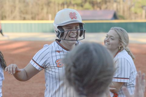 Sophomore Chesnee Strickland celebrates with her teammates moments after a walkoff double in the 11-10 win over the Lady Dragons of Jefferson on March 12. (Photo/Benjamin London)