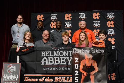 Harrison Krause (middle on first row) surrounded by family and coaches as he signs with Belmont Abbey College to continue his academic and wrestling career.