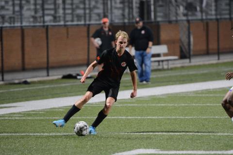 Junior midfielder Will Bell dribbles down the sideline in the 2-1 win over Monsignor Donovan on March 14. (Photo/Benjamin London)