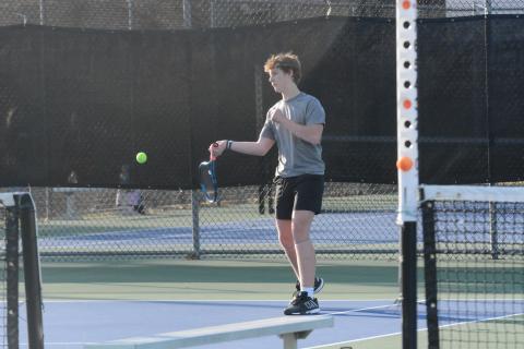 Sophomore Jackson Starrett returns a serve earlier in the season as he captured the win at No. 1 singles, 6-3, 6-2, in the 4-1 loss to Sumter County in the Sweet Sixteen on April 29. (Photo/Benjamin London)