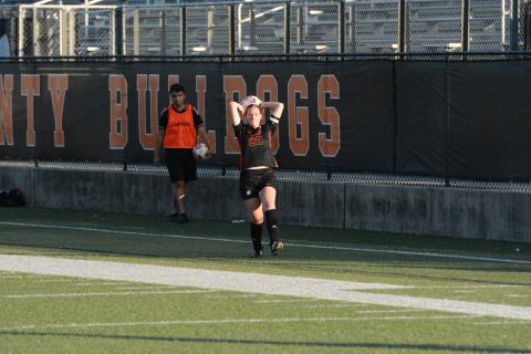 Junior defender Juliette Cason throws the ball into play earlier in the season. (Photo/Benjamin London)