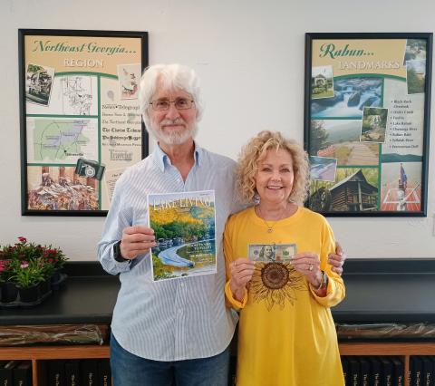 Spring 2025 Lake Living cover winner Morgan Harvill, left, is pictured with his wife, Judy. The magazine cover features a MasterCraft boat on Lake Rabun in Rabun County at the narrows around September 2024. In addition to gracing the cover of Spring 2025 Lake Living, Harvill received $100. (Photo/Megan Horn, The Clayton Tribune)