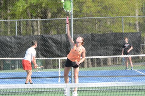 Lyla Phillips serves the ball as she picked up a 6-2, 7-5 win at No. 1 singles in the 3-2 loss to East Jackson on April 15. (Photo/Benjamin London)