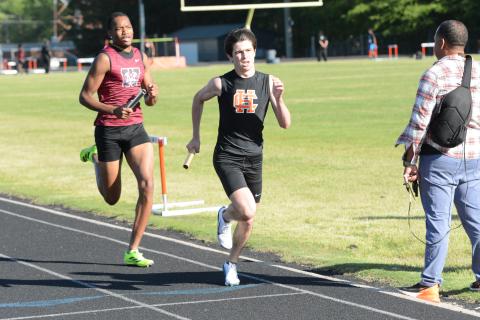 Sevyn Singleton (right) runs in the first leg of the 4x800-meter relay as he helped the Dogs place first in the event at the home meet against Westside on April 15. (Photo/Benjamin London)