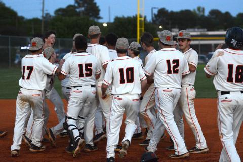 The Hart County baseball team celebrates after a 5-4 walkoff win on senior night at Saye Field on April 16. (Photo/Benjamin London)