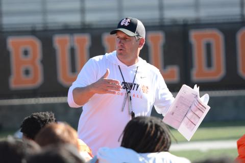 Head football coach Cory Dickerson speaks with the team after their third practice of the spring on May 6. (Photo/Benjamin London)