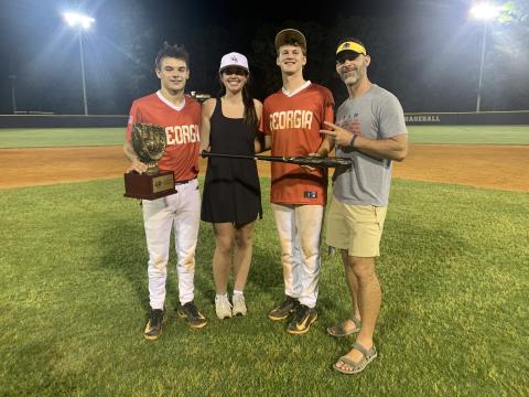 Pictured from left are Diamond Dogs’ senior infielder Pearce Mewborn with the championship trophy, Lake Hartwell FCA’s Olivia Morris, Diamond Dogs’ senior infielder and pitcher Riley Kesler with the MVP trophy and Lake Hartwell FCA’s Chad Posey. (Photo/Benjamin London)