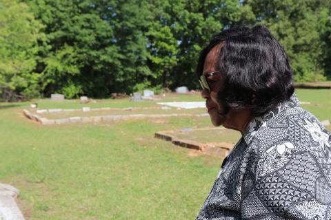 Diane Merritt, owner of surrounding land and congregant of Harmony Grove Missionary Baptist Church, looks over the historic Harmony Grove Baptist Church Cemetery. The land has been passed down through generations since Ervin Merritt, Merritt’s great-grandfather and former slave, inherited over 600 acres from the Bowers family. (Photo/Adriana Cascio)