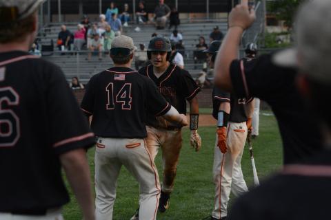 Senior catcher Pearce Mewborn (right) celebrates with freshman Slate Osborne (14) after scoring a run against Thomson in the first round of the state playoffs. (Photo/Benjamin London)