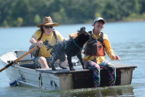 Jato, a 3-year-old male Junior PWD from Asheville, North Carolina, shakes off water on Allen Reindorf (left) and Morgan Jennings (right) after performing tricks during the water trials. (Photo/Adriana Cascio)