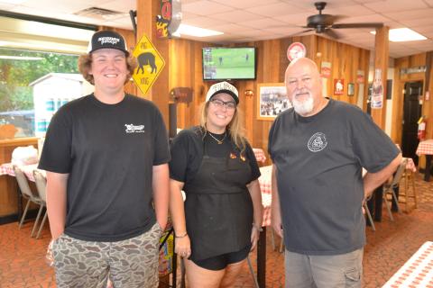 Three generations of the Beck family have worked at Backstreet Bar-B-Q over the last 25 years, including left to right, Kain Norris, son of co-owner Kayla Segars, Segars and co-owner Bob Beck. Segars is the daughter of former co-owner Frankie Beck, Bob’s brother. (Photo/Adriana Cascio)