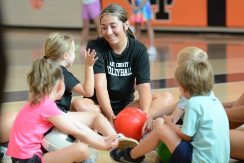 Rising junior Josee Fleming (middle) coaches her group during the annual Kids Volleyball Camp. (Photo/Benjamin London)