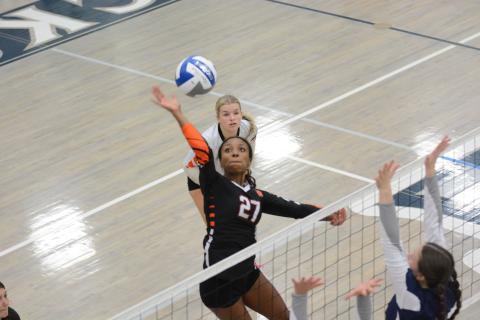 Rising sophomore middle Trinity Freeman (27) goes up to spike the ball during a 2024 match. (Photo/Benjamin London)