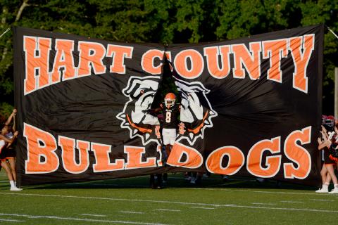 Senior CJ Cowins led the Dogs through the spirit banner to kickoff the evening. See full coverage of Friday’s scrimmage in our sports section. (Photo/Benjamin London)