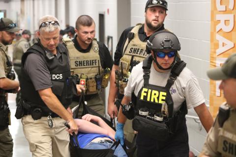 First responders carry a student actor out of the building during an Emergency Response Drill on Aug. 1 at Hartwell Elementary School. (Photo/Grayson Williams)