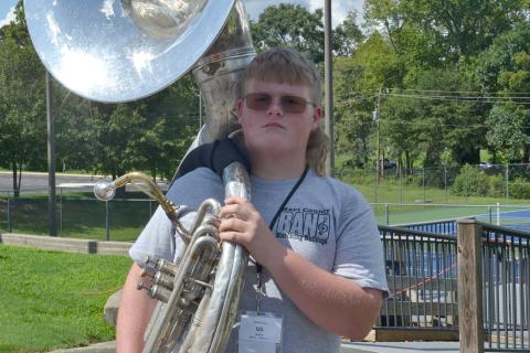 Sousaphonist Kabil Carey holds his sousaphone on his shoulder with pride after being named member of the week for this week’s High Notes series. Carey was selected for his great attitude and dedication to learning during his first marching season. (Photo by Adriana Cascio)