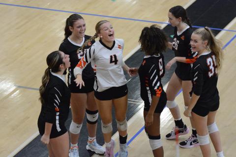 The Volley Dogs celebrate after picking up the 2-0 win (25-18 and 25-18) over the defending AAA state champion, the Lady Dragons of Jefferson Sept. 4. (Photo by Benjamin London)