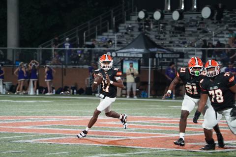 Junior quarterback Kurston Curry rolls outside the pocket to throw on the run during the 19-14 loss to Lumpkin. (Photo by Ric Williams)