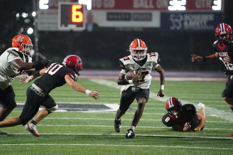 Junior quarterback Kurston Curry scores on the quarterback keeper from 32 yards out in the 24-14 loss to Flowery Branch Sept. 5. (Photo by Ric Williams)